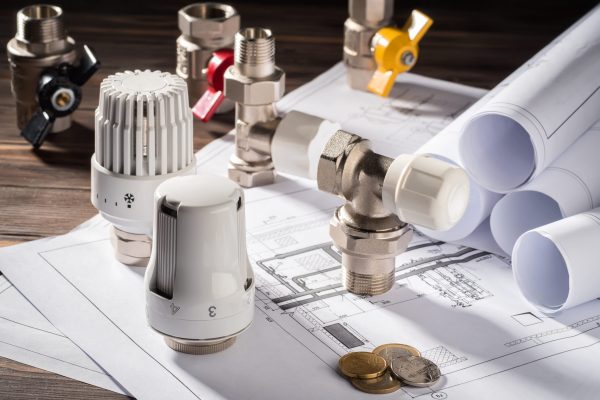 Thermostatic Head Valve for Radiator Heater Coin Money notepad for entries Heating Project Boiler room house Heat Supply Building Concept of Energy saving and conservation to pay for public service.